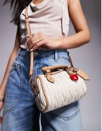 ruched mini bowler bag with charms in cream